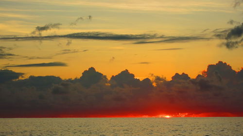 Scenic view of sea against romantic sky at sunset