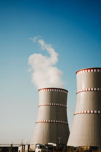 Low angle view of smoke stack against sky