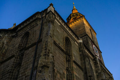 Low angle view of historic building against clear blue sky