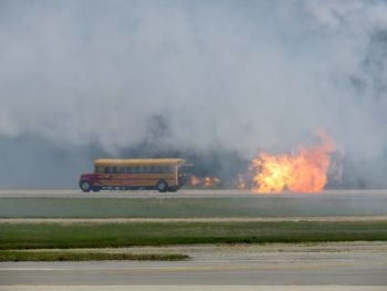 Jet engine school bus with flame and smoke on road
