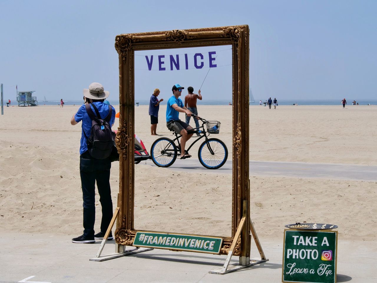 MAN AND BICYCLE SIGN ON BEACH