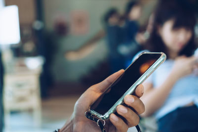 Midsection of man using mobile phone