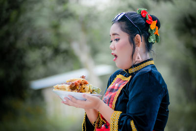Portrait of young woman with food
