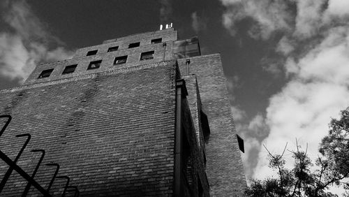 Low angle view of historical building against cloudy sky