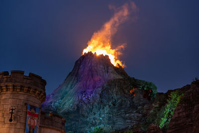 Low angle view of illuminated building against sky at dusk