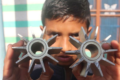 Close-up portrait of man holding camera