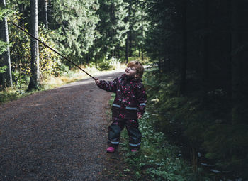 Toddler girl holding stick