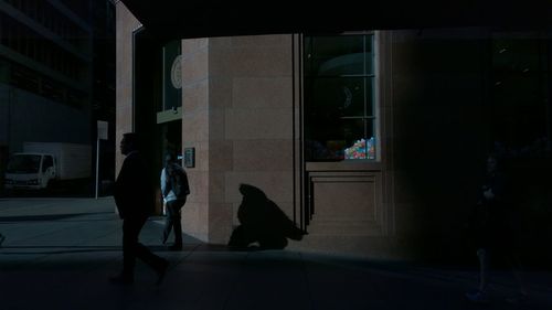 Full length of woman standing in front of building