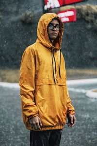 Full length of man standing on wet landscape during rainy season
