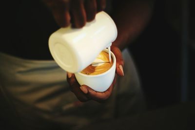 Close-up of hand holding coffee cup