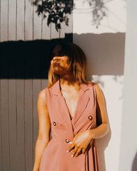 Beautiful woman standing against wall