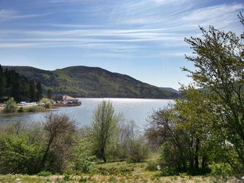 Scenic view of lake against cloudy sky