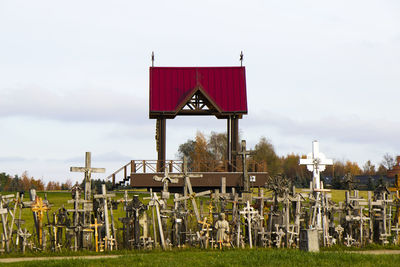 Lifeguard hut on field against sky