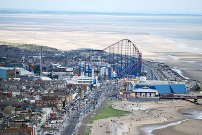 High angle view of cityscape by sea against sky