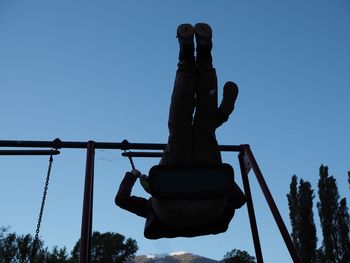 Low angle view of silhouette man against clear sky