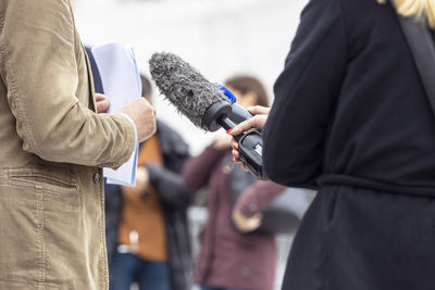 Whistleblower holding document and giving statement at media event or press conference