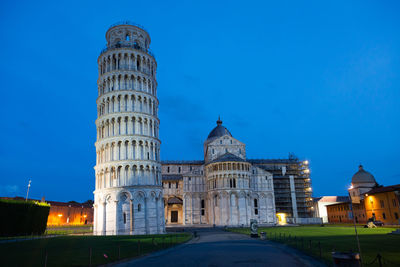 Low angle view of illuminated buildings against sky at night