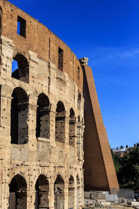 Low angle view of historical building against blue sky