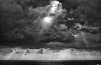Scenic view of sea against cloudy sky