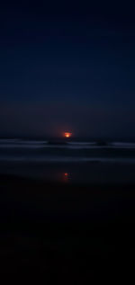 Scenic view of sea against sky at night