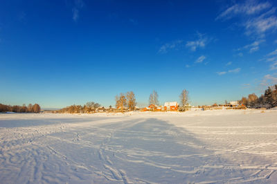 Scenic view of field against sky during winter