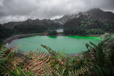 Scenic view of lake and mountains against sky