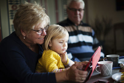 Grandmother and granddaughter using digital tablet