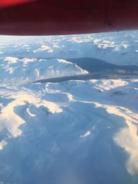 Aerial view of snowcapped mountain against sky