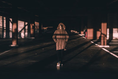 Full length of woman standing at railroad station