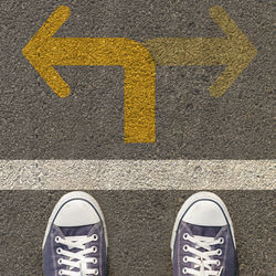 Low section of man standing on road