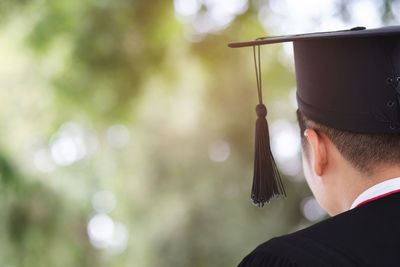 Rear view of man wearing mortarboard