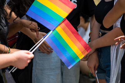 People in the pride parade on the street with gay rainbow flag, supporting gay rights and diversity