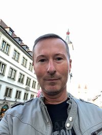 Portrait of young man against sky