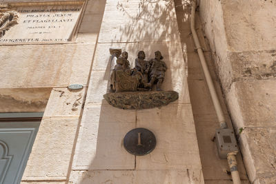 Low angle view of statue against building