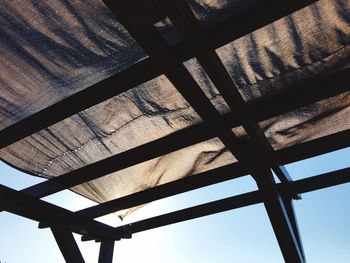 Low angle view of canvas textile on gazebo against sky