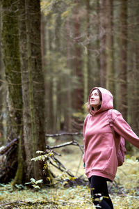 Woman standing in forest