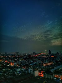 High angle view of city lit up at night