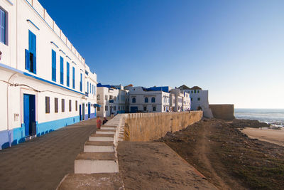 View of beach against clear blue sky