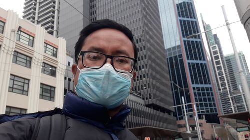 Portrait of man against buildings in city