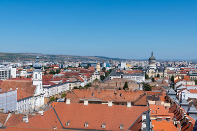 High angle view of townscape against clear blue sky