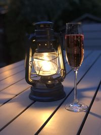 Close-up of illuminated lamp on table