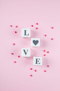 High angle view of heart shape on pink table