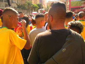 Rear view of people standing on street