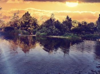 Scenic view of lake at sunset