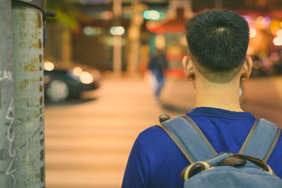 Rear view of man standing at street