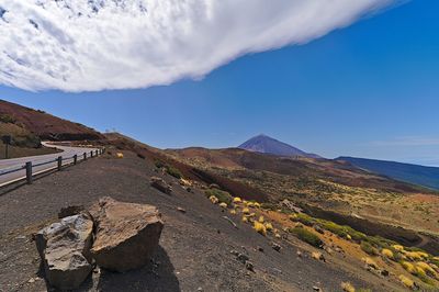 Scenic view of mountain against blue sky