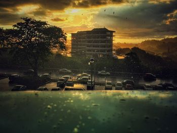 Buildings against cloudy sky at sunset