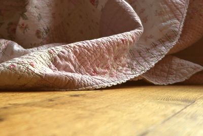 Surface level of blanket on hardwood floor