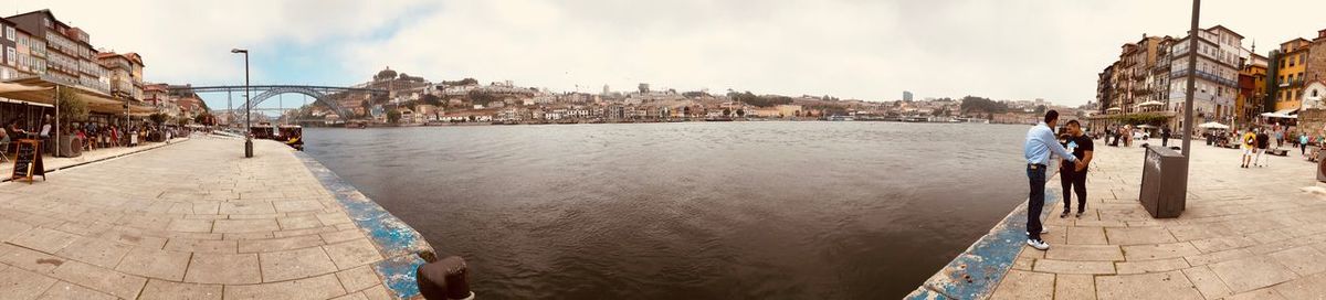 Panoramic view of people in city against sky