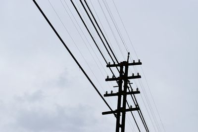 Low angle view of electricity pylon against sky